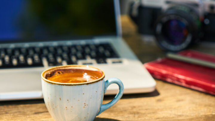 Coffee sitting by a laptop