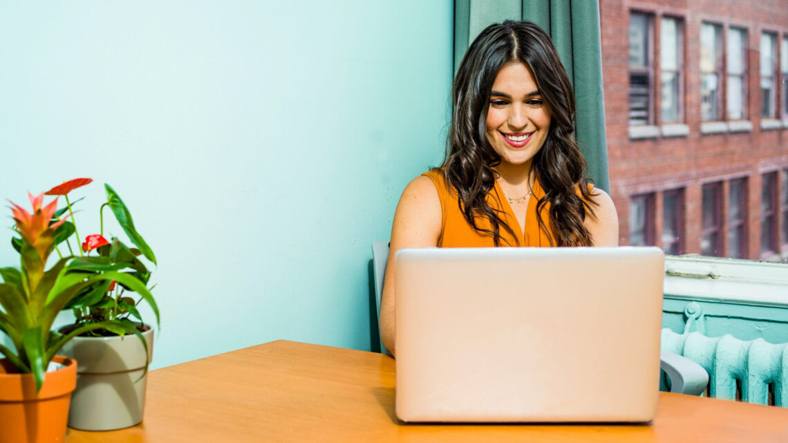 woman on computer using Chat GPT along with it's plugins