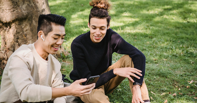 2 friends looking at memes on a phone